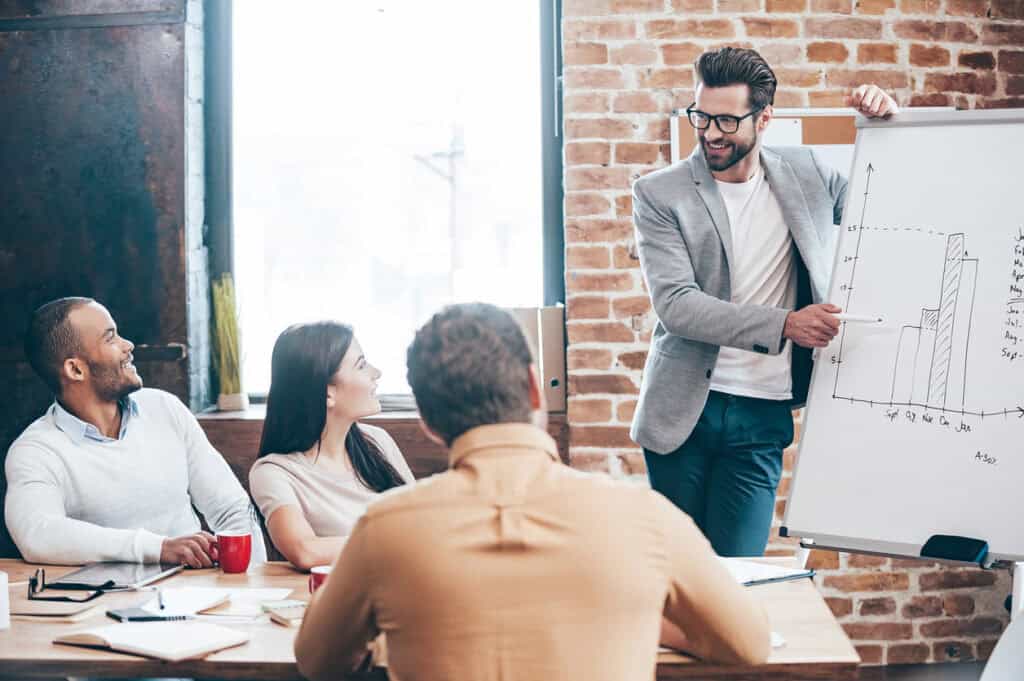 man giving a presentation pitch to his colleagues to prepare for investor funding and investor scrutiny