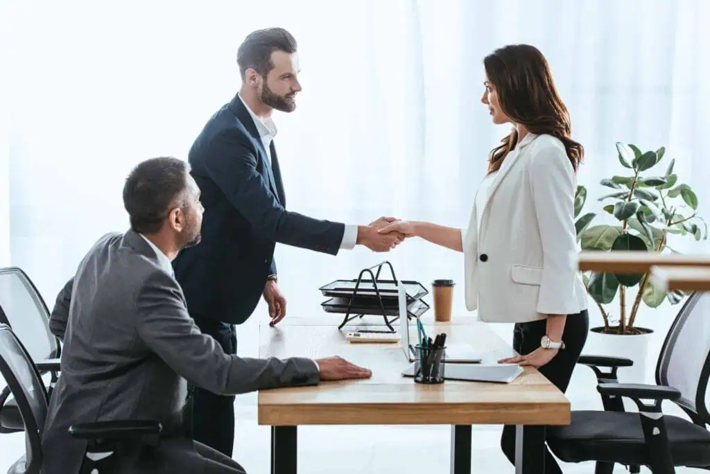 business woman shaking hands with a male investor after securing one of the start-up funding stages 